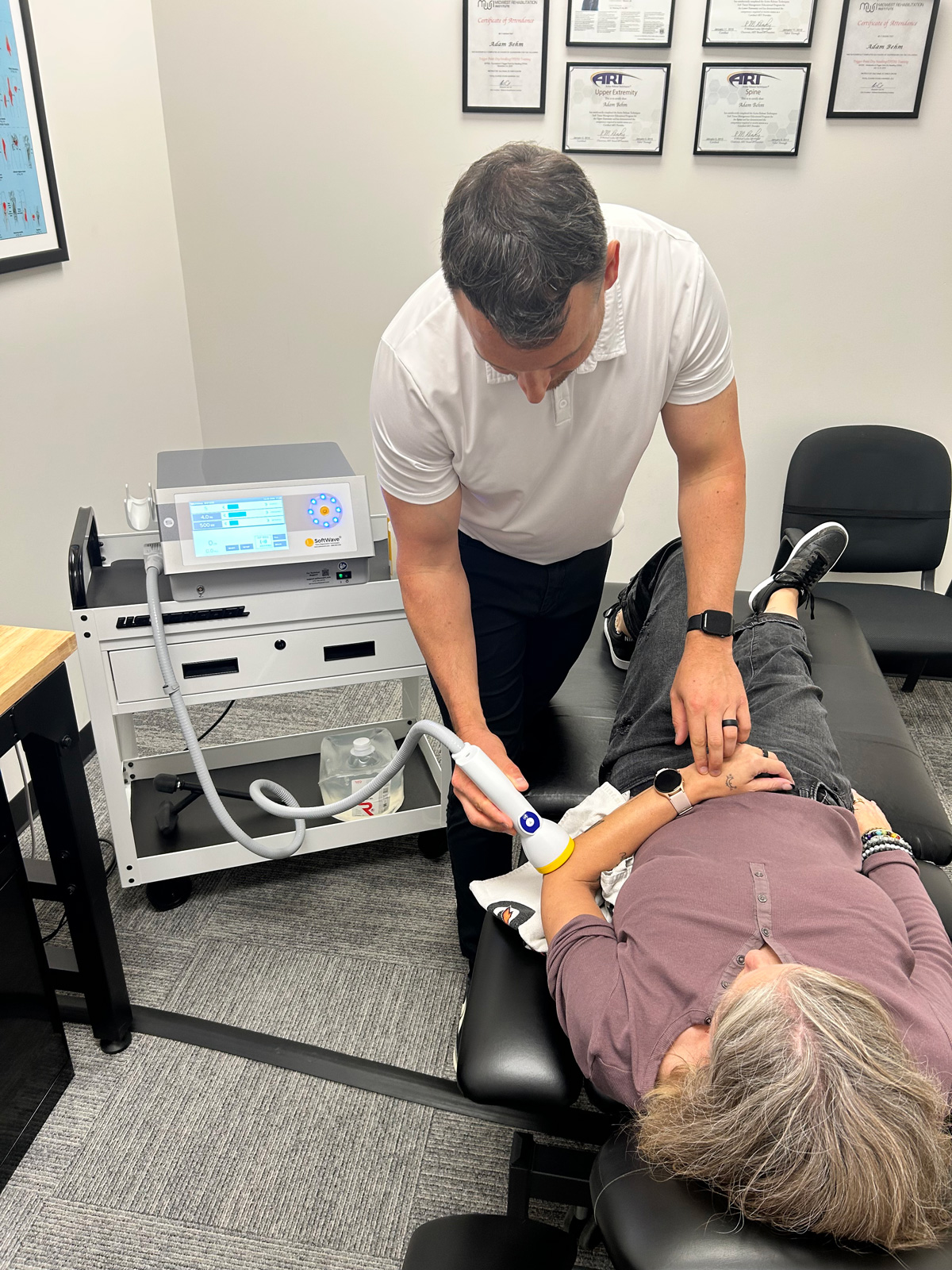 close up of using softwave therapy on a patient's elbow
