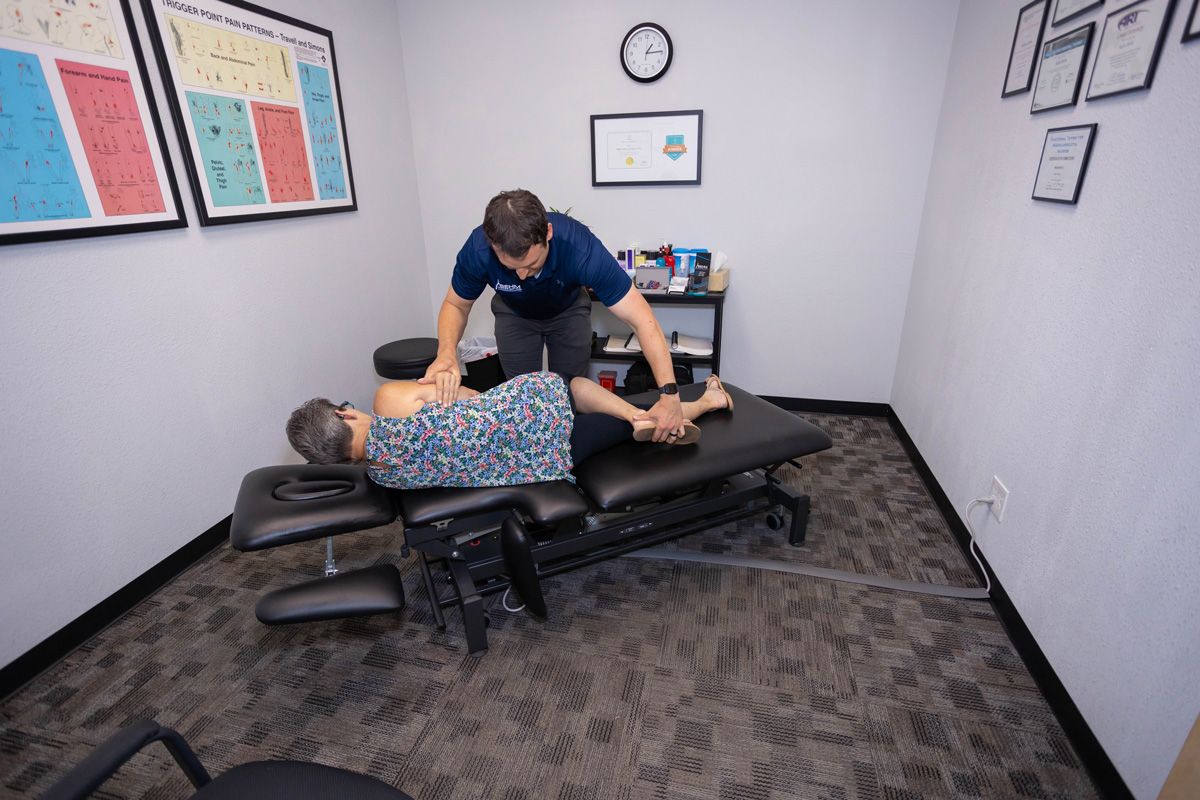 chiropractor prepping patient for traction treatment