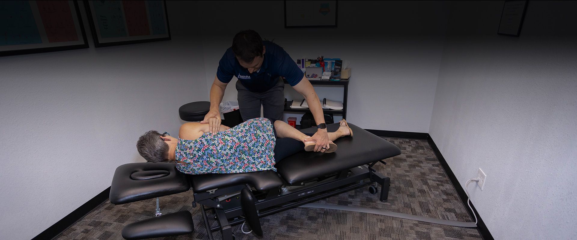 chiropractor providing adjustment and traction to patient's back