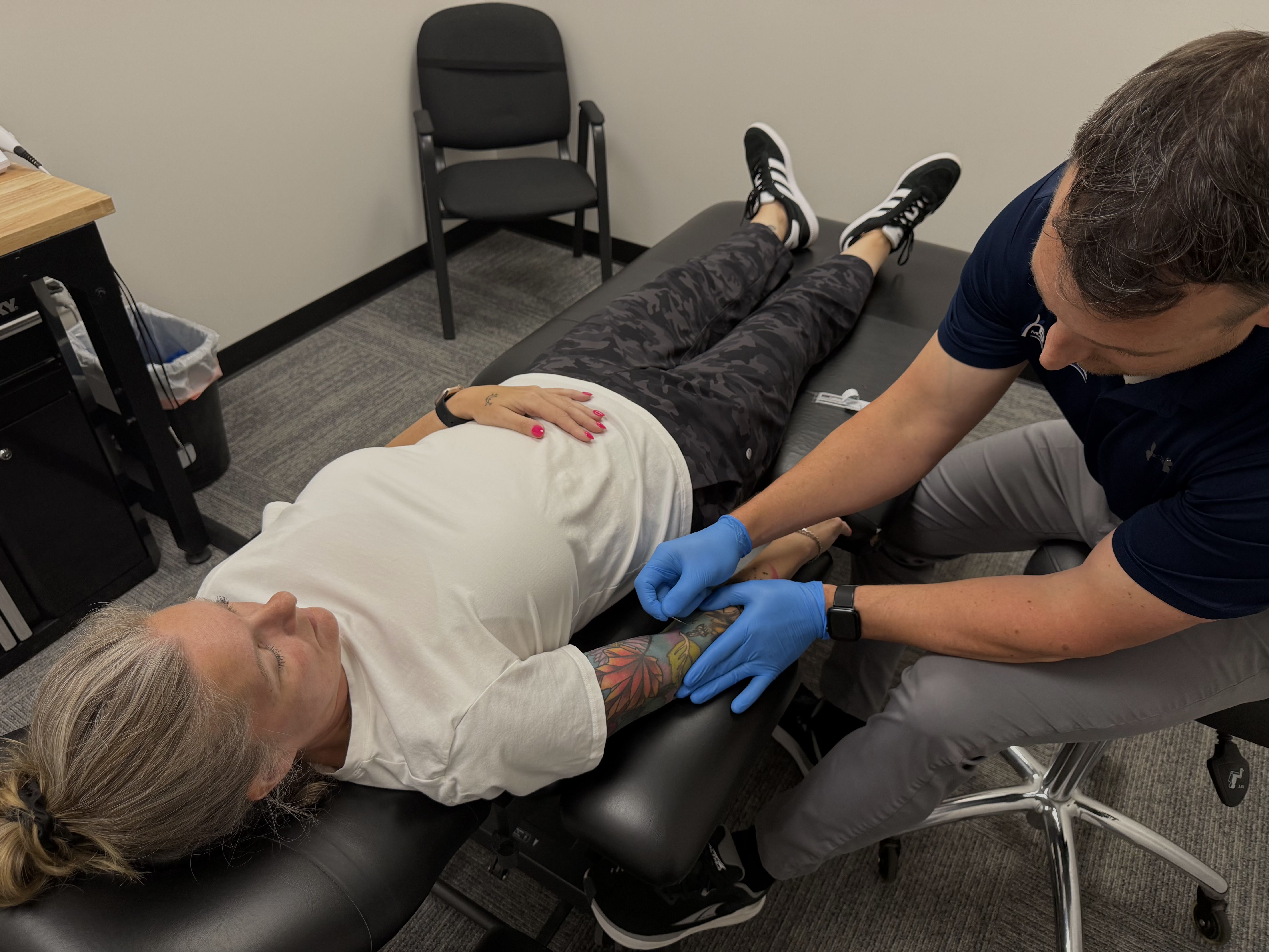 chiropractor, Adam Behm, treating a patient