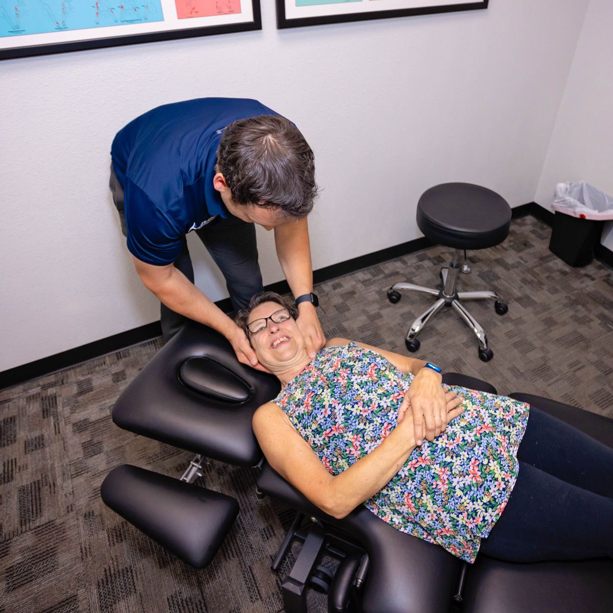 chiropractor adjusting patient's neck