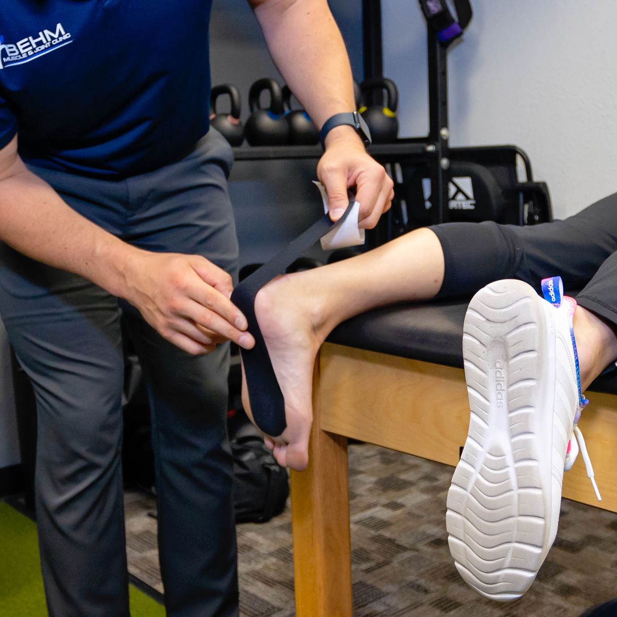 kinesiotape being applied to a patient's foot