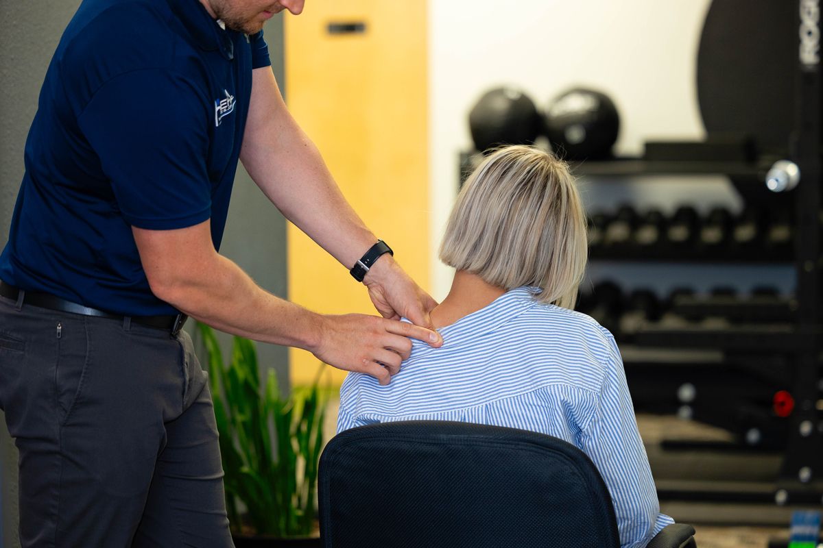 Chiropractor performing active release techniques (ART) on levator scapula