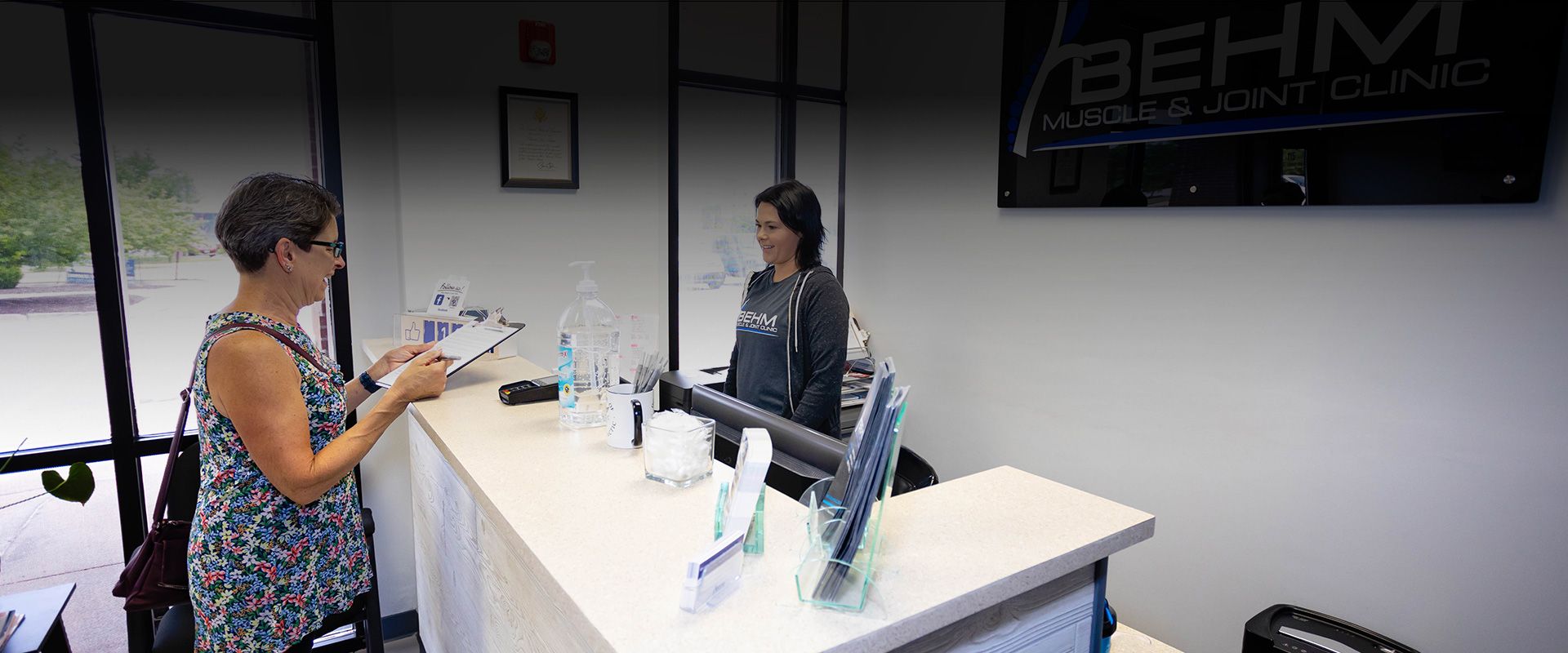 chiropractic staff receiving information from new patient